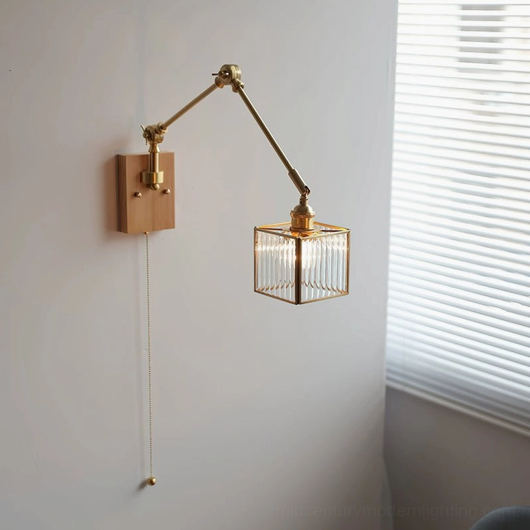 Side profile of mid-century modern wall lamp showing brass arm articulation, light wood mounting base, and textured glass diffuser