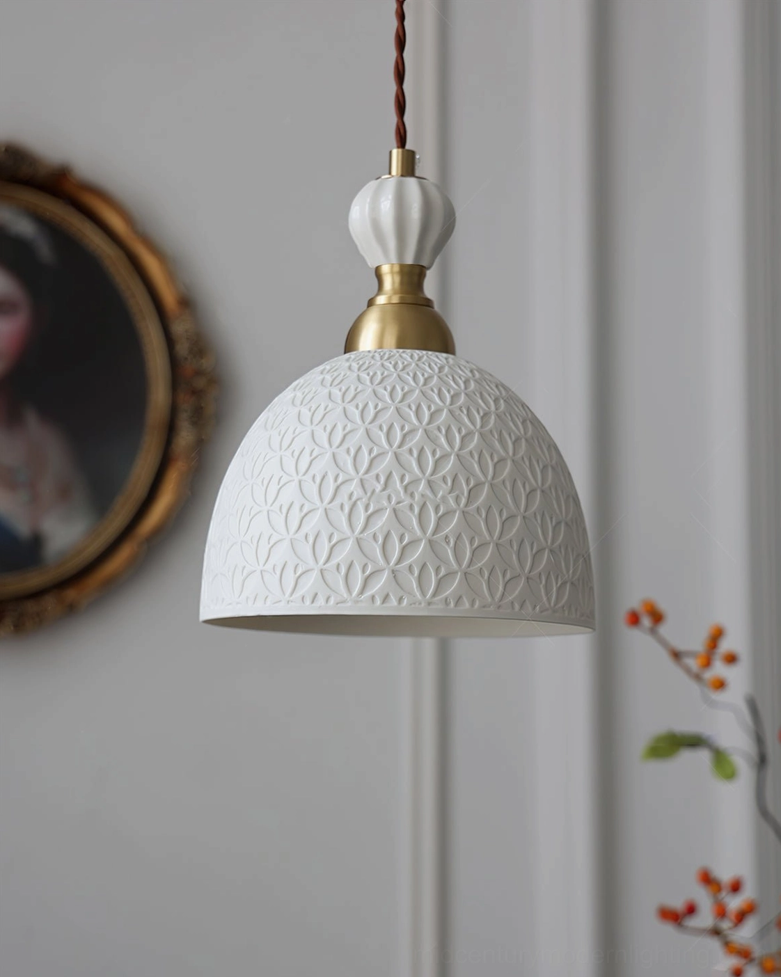 Artisan-made white ceramic pendant shade with distinctive sculptural form and brass top