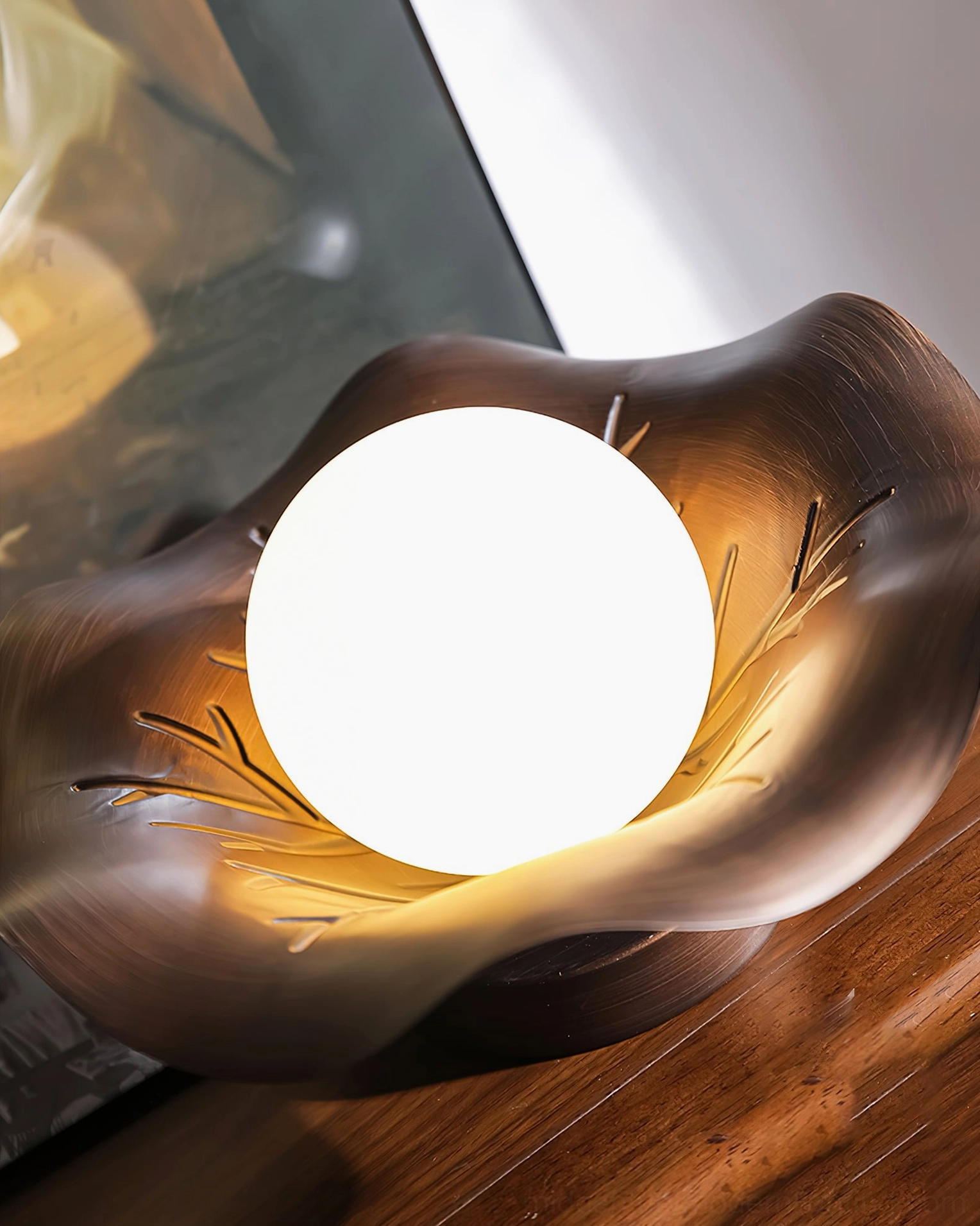 Arundel lamp close-up carved leaf petal details frosted bulb wooden tabletop