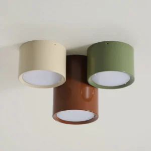 Staggered arrangement of Asher cylindrical ceiling drums in varying heights, showcasing mid-century modern minimalist lighting design
