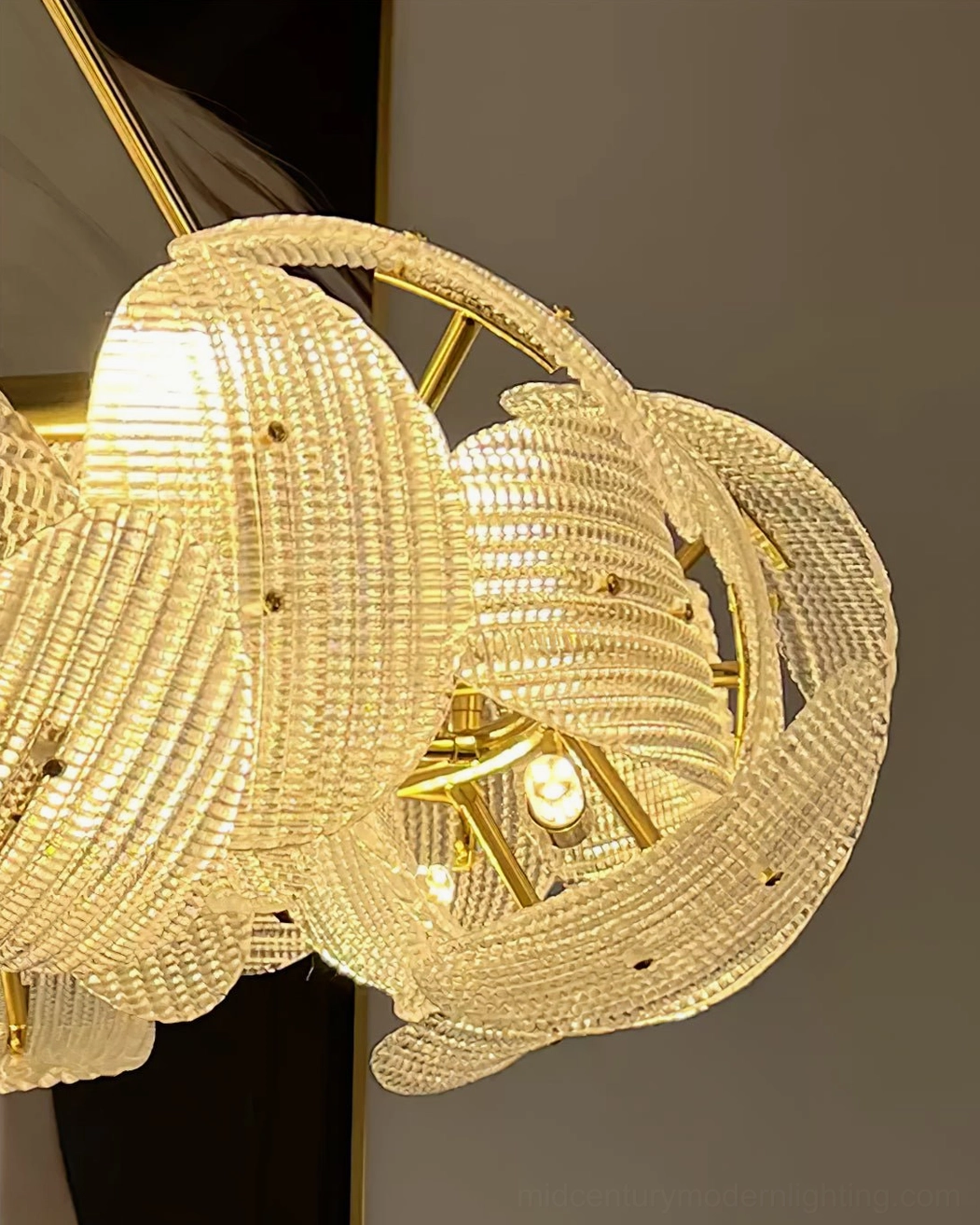 Aster chandelier extreme close-up ribbed glass texture bulb detail gold frame
