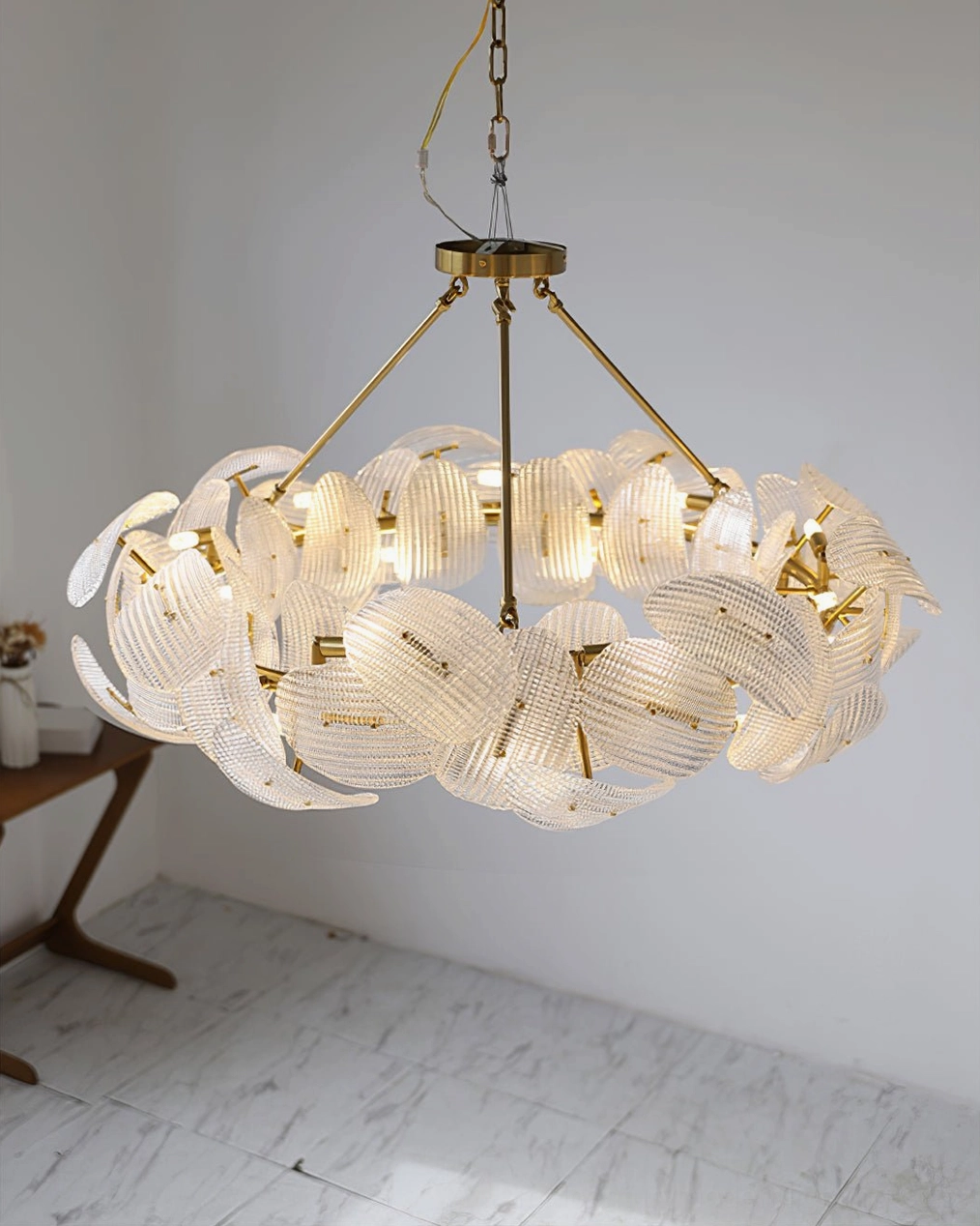Aster gold chandelier multiple bulbs illuminated glass shades ambient light