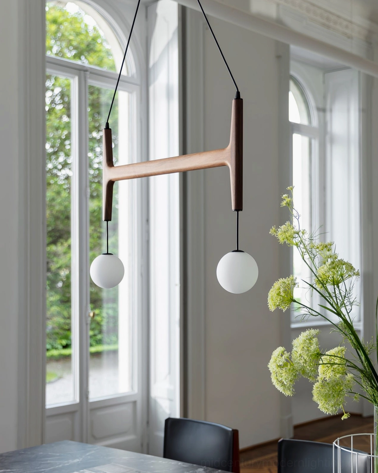 Astra suspension light with black cables and frosted white glass shades in neutral interior environment