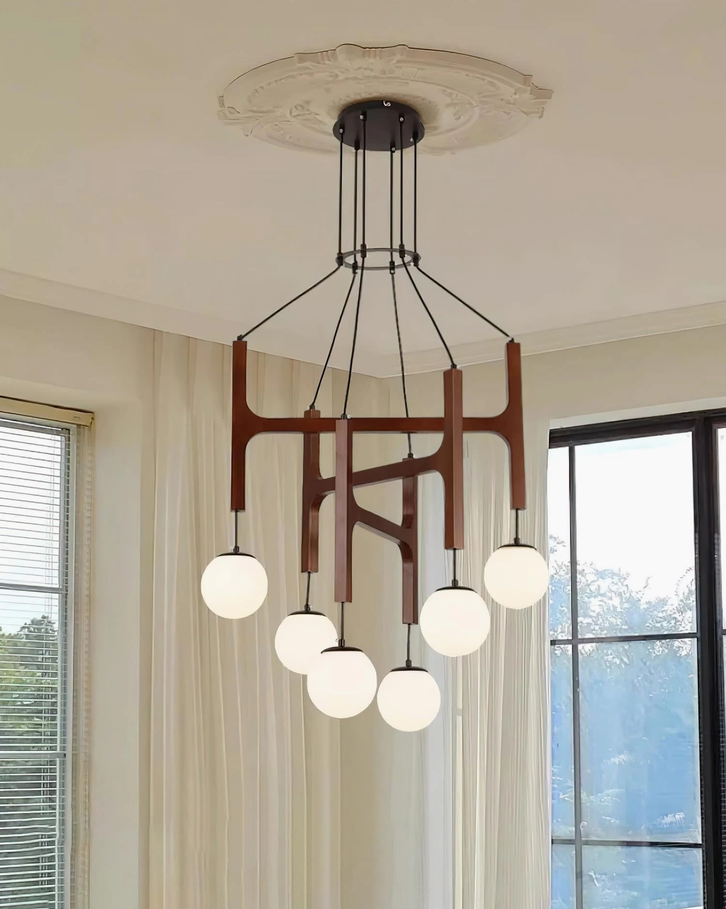 Astra wooden chandelier with natural walnut finish and multiple pendant lights in contemporary home setting
