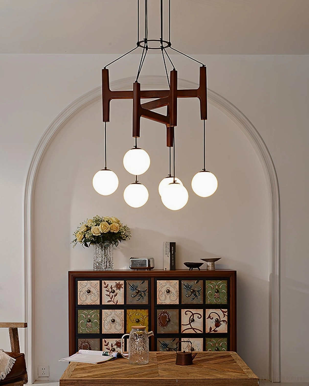 Astra geometric wooden chandelier with frosted glass shades in arch-walled vintage dining nook with retro furniture