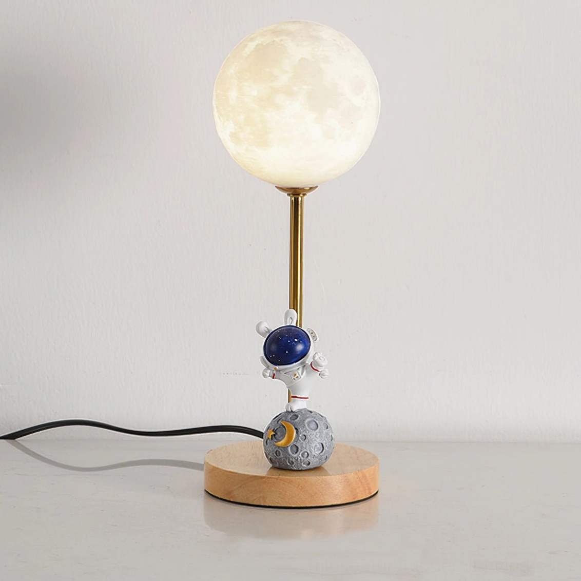 Astronaut moon lamp base close-up showing wooden construction quality and metal mounting details with gold accents