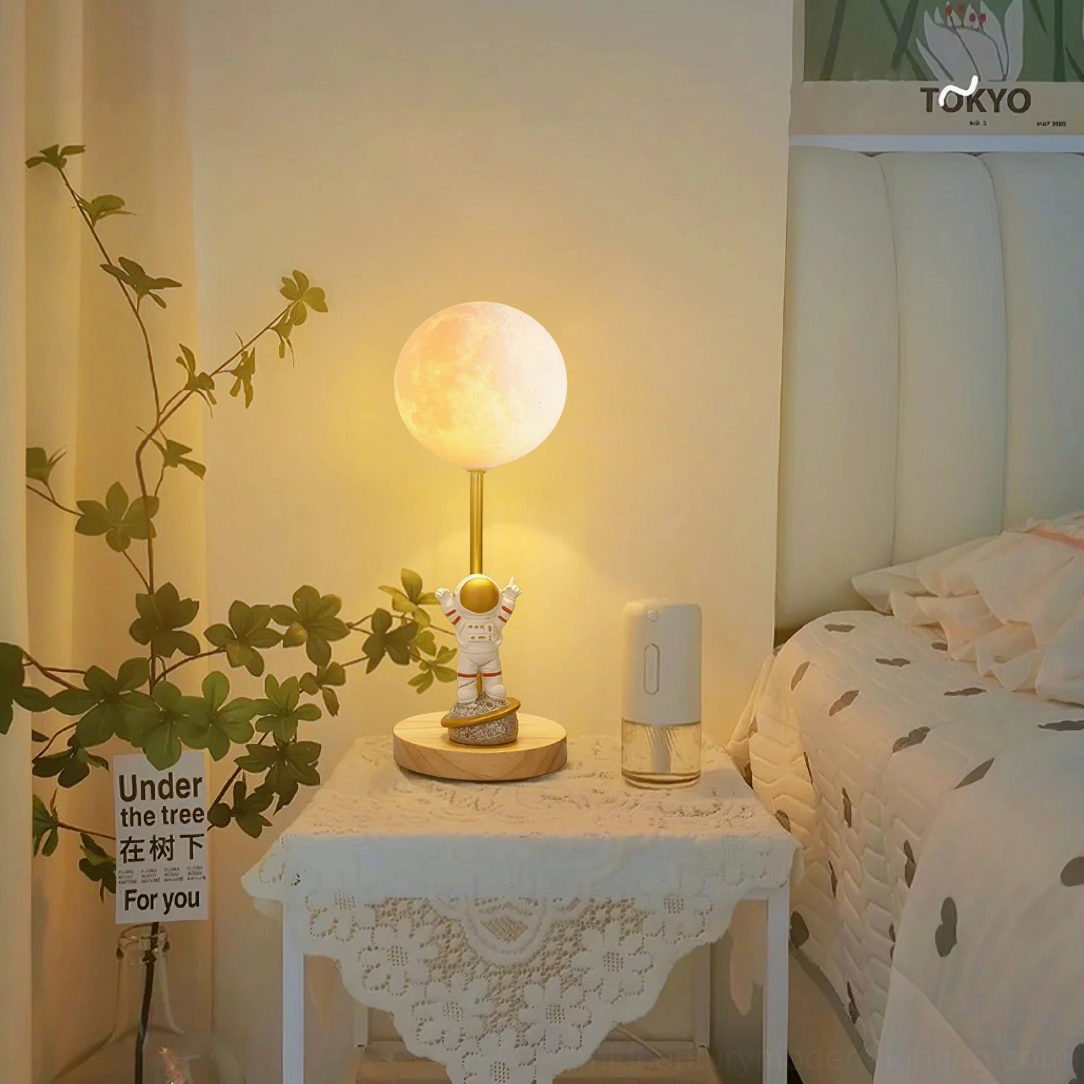 Astronaut moon lamp in bedroom bedside setting with warm ambient light illuminating green plant and cozy interior design