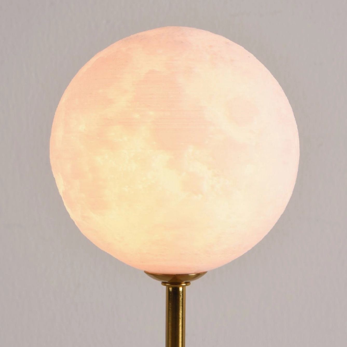 Astronaut moon lamp with gold metalwork finish showing contemporary elegance and warm metal tone highlights
