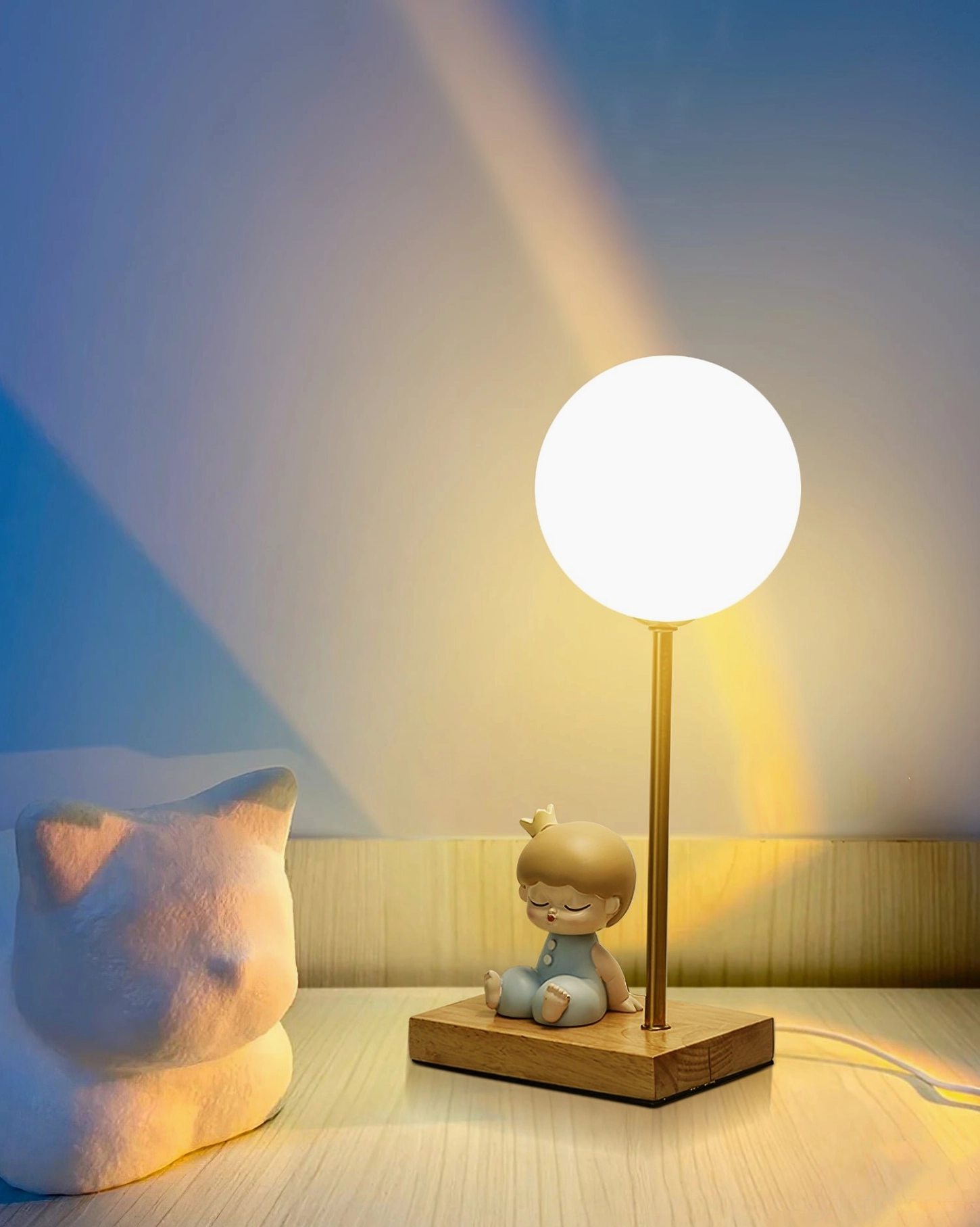Astronaut moon lamp illuminated showing warm white LED light diffusion through lampshade in dark room setting