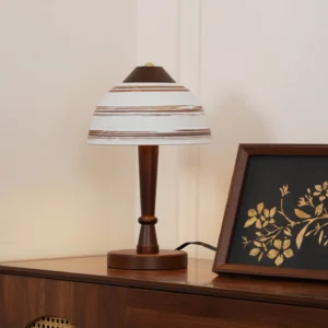 Mid-century modern Athena table lamp three-quarter view on wooden console table with framed artwork and gold decor