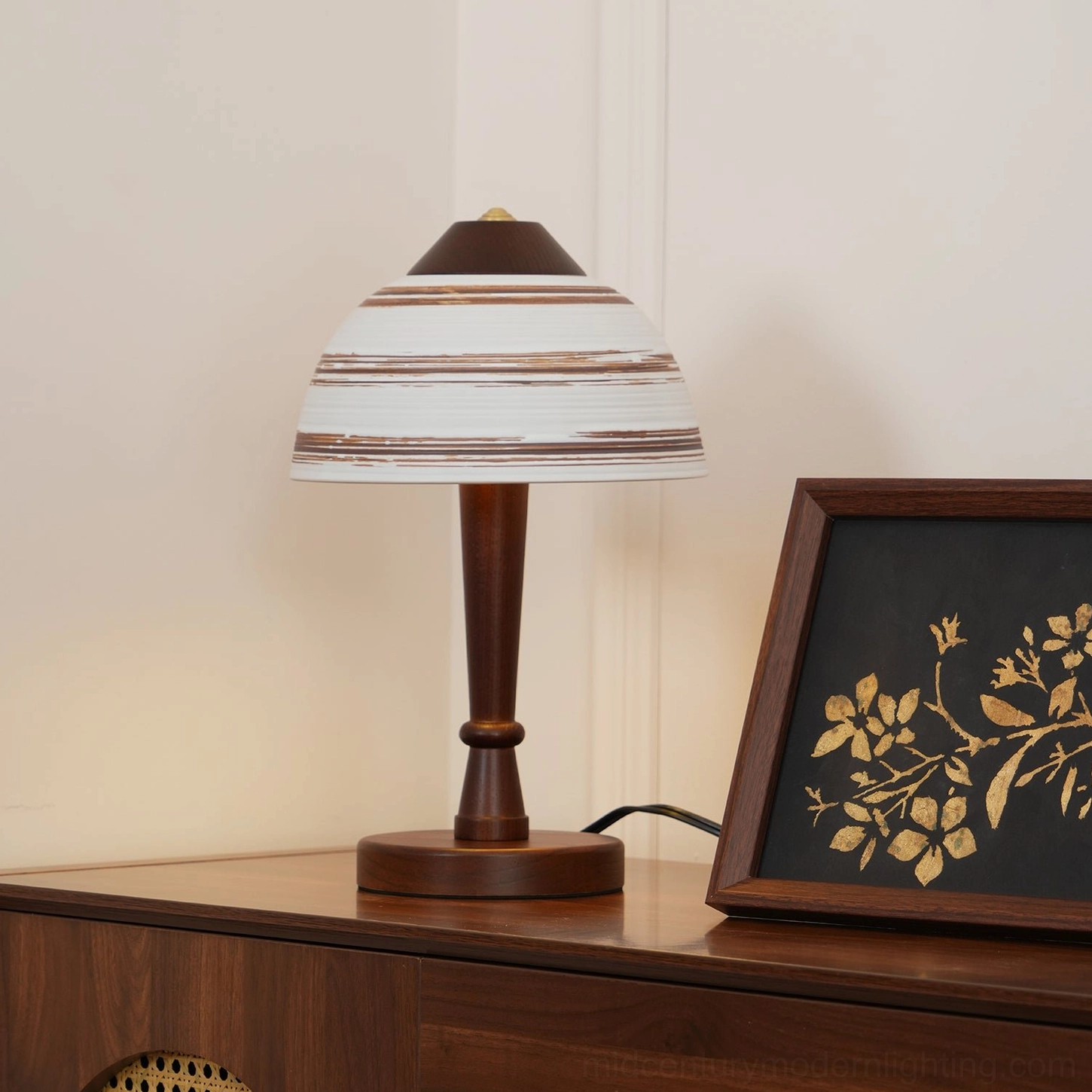 Mid-century modern Athena table lamp three-quarter view on wooden console table with framed artwork and gold decor