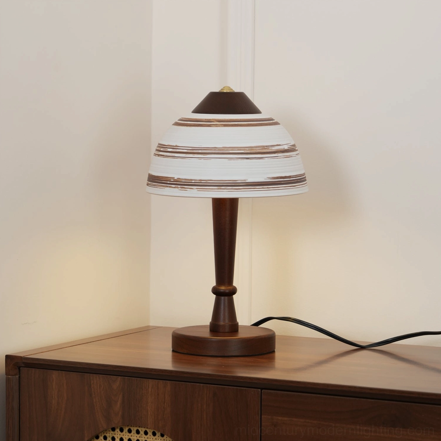 Athena table lamp side angle view showing ceramic shade texture and turned walnut pedestal base on console