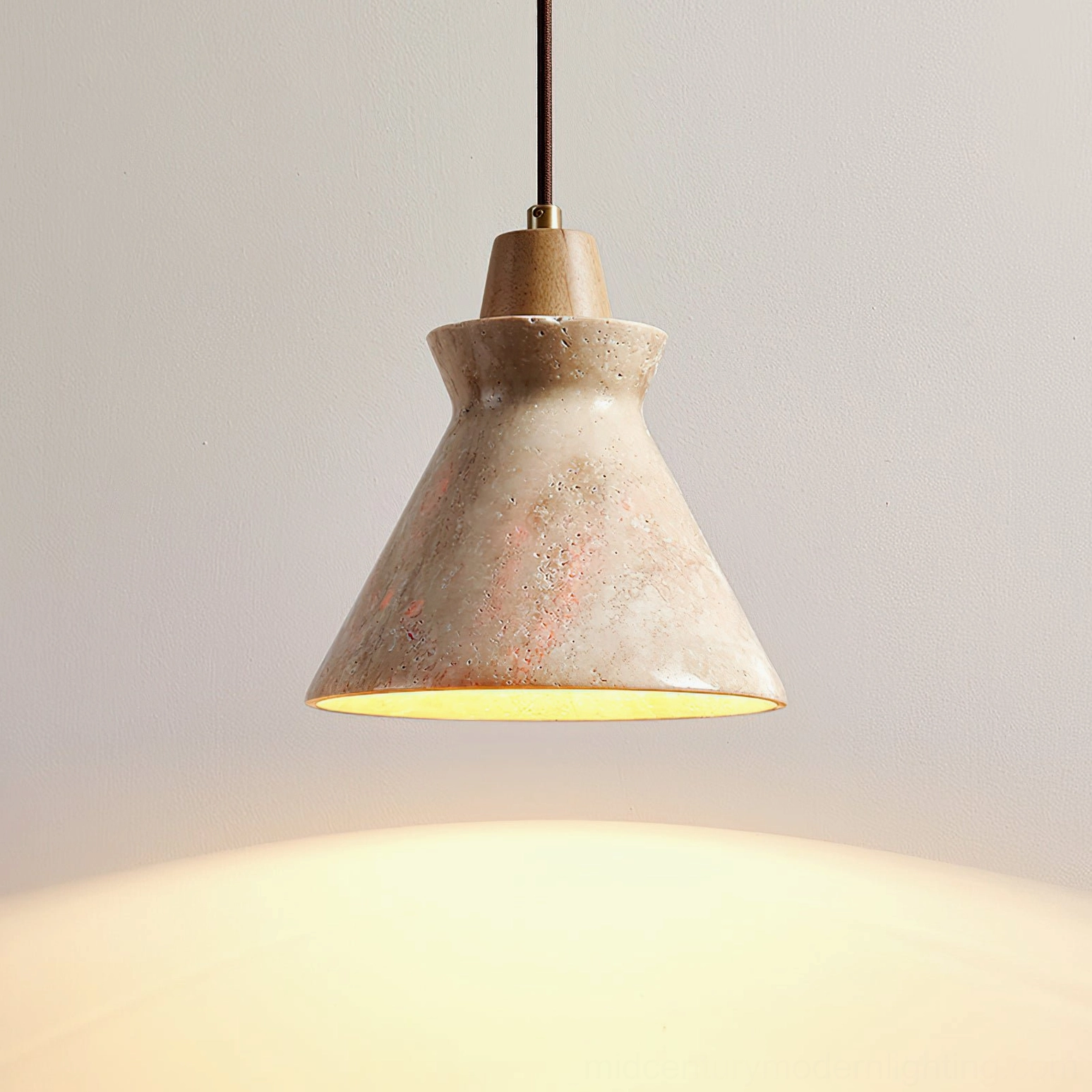 Athena travertine pendant light installed in bedroom setting, stone cone shape and brass fitting