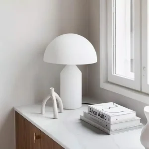 Atollo Glass Lamp on modern home cabinet with books and decorative objects