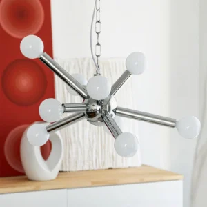Mid-century atomic age chandelier over modern countertop, white glass globe lights with chrome radial arms, interior design showcase