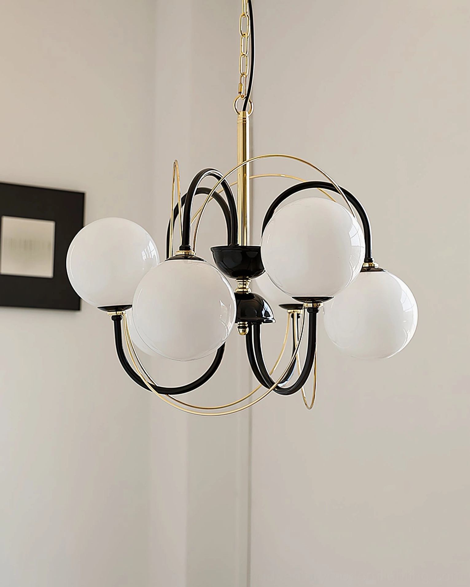 Atomic Orbit mid-century modern chandelier installed in contemporary dining room with ambient lighting