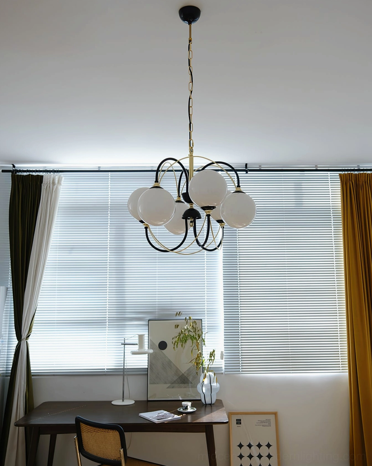 Ceiling hanging Atomic Orbit chandelier in home study room, wide interior view showcasing black-gold sculptural frame