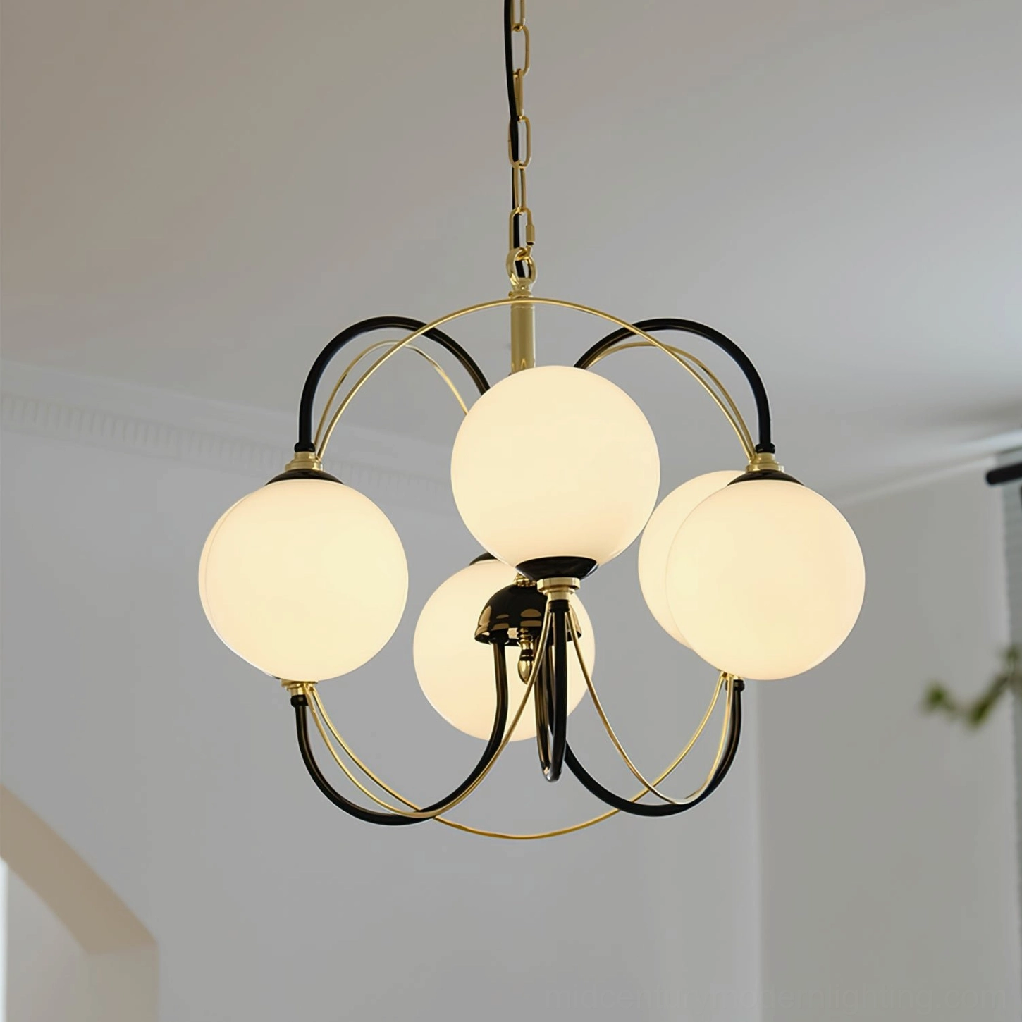 Mid-century modern Sputnik chandelier with warm LED lighting, six glass globes overhead view in minimalist room