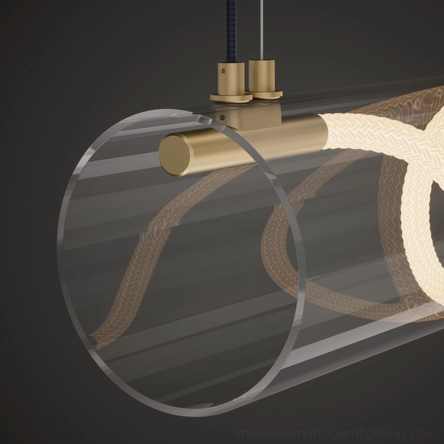 Angled close-up view of Attalea linear pendant chandelier featuring clear acrylic tube and hidden brass hardware on dark background