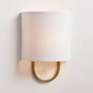 Brass Atticus wall lamp with oversized off-white drum shade, minimalist mid-century design detail shot
