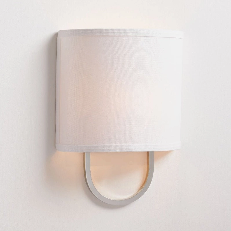 Polished nickel Atticus mid-century modern wall sconce with off-white fabric drum shade, architectural lighting fixture