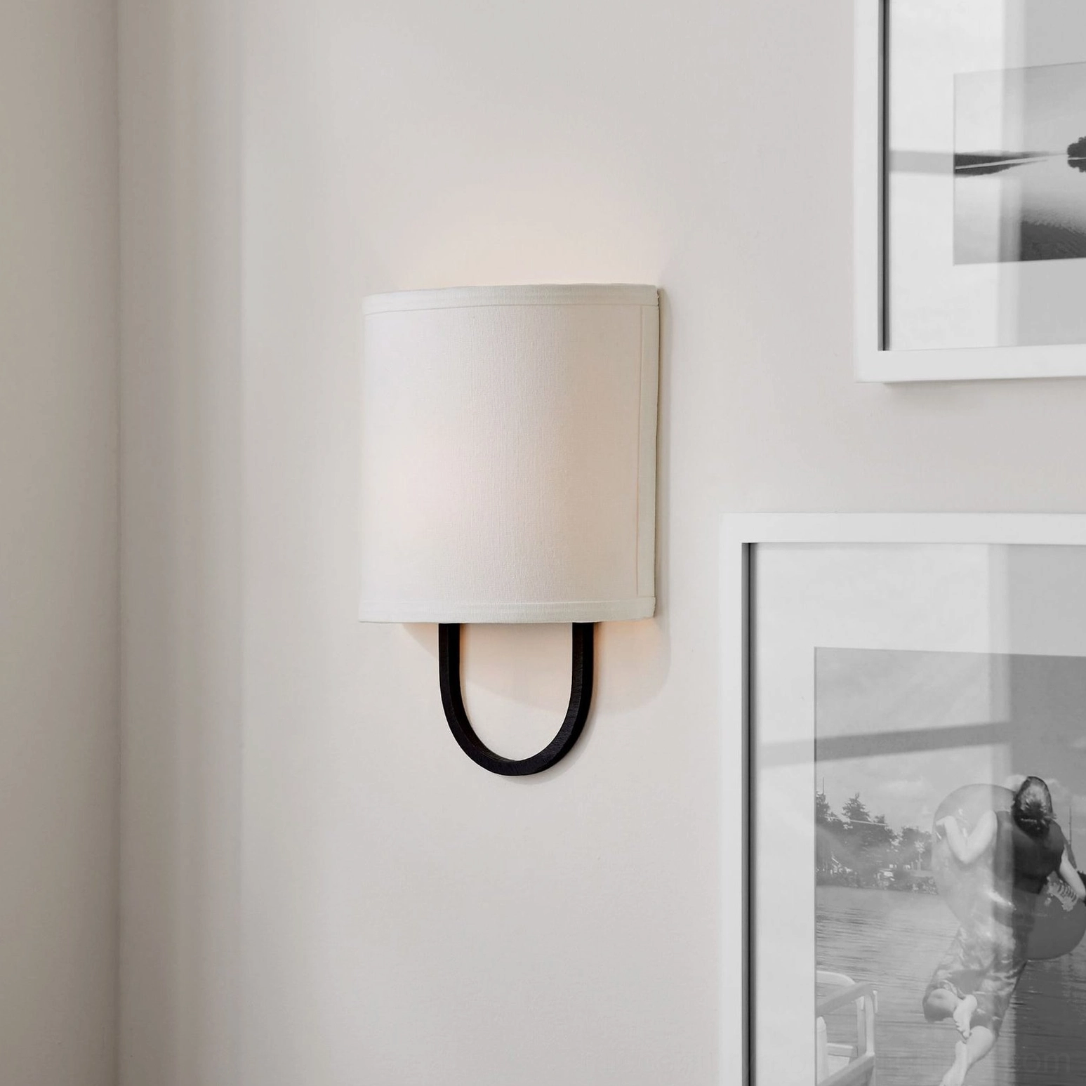 Atticus wall lamp with slim black U-mount and small rectangular off-white shade, gallery wall lighting