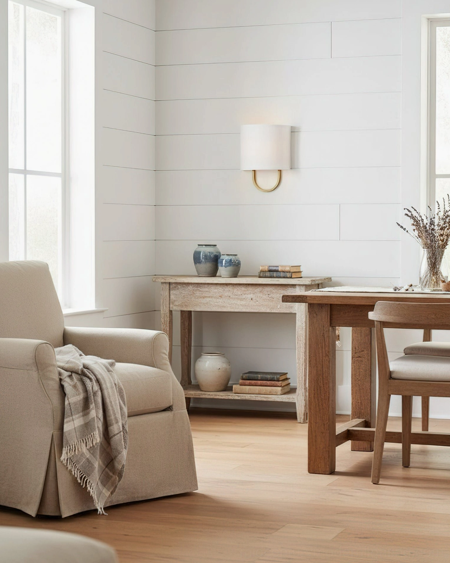 Atticus modern wall sconce in rustic dining lounge space with contemporary cottage aesthetic