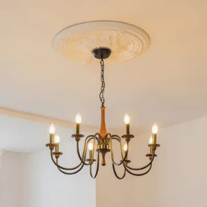 Aubrey chandelier installed in elegant living room with decorative ceiling medallion and warm candle-style bulb lighting