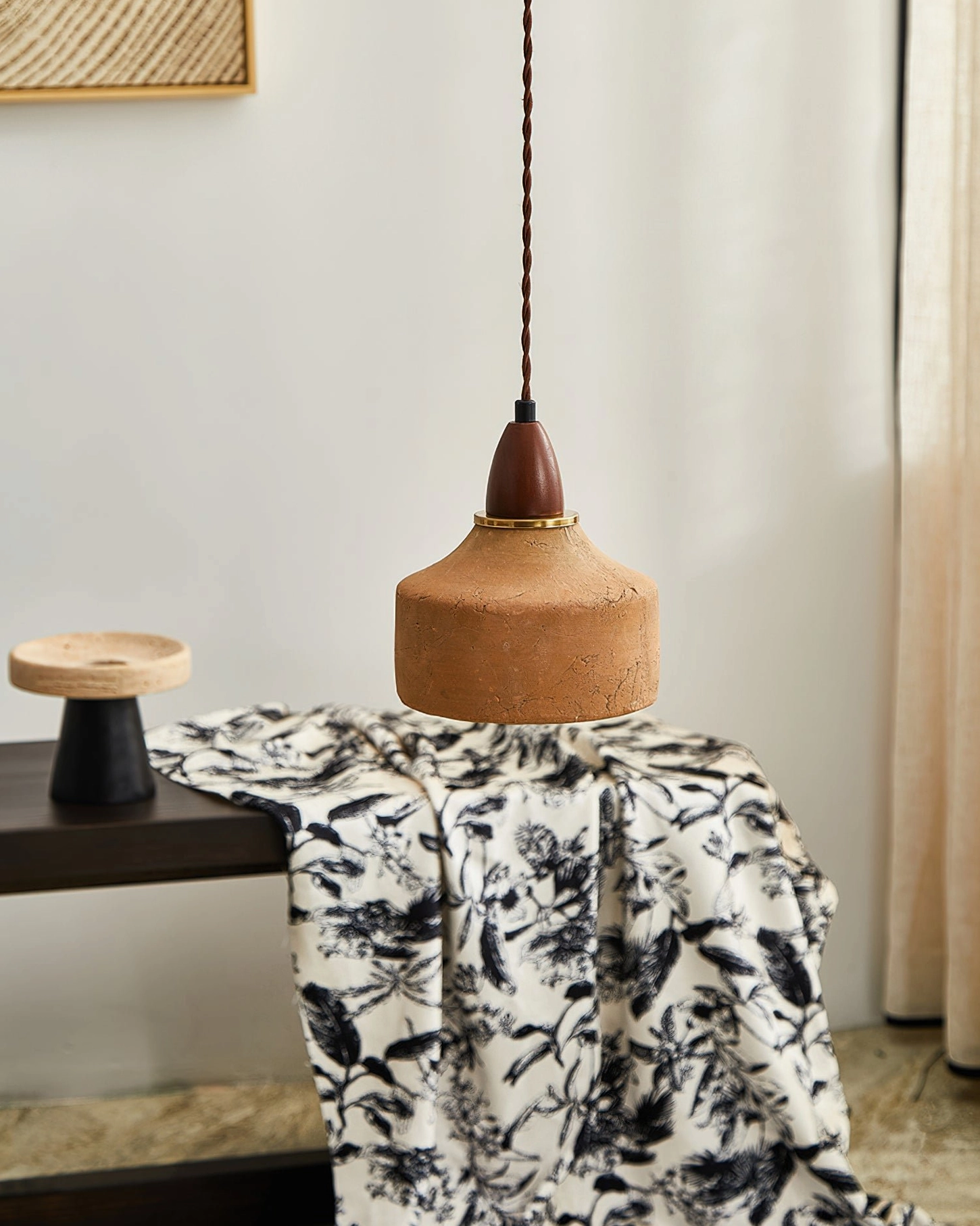 Lit Auburn pendant fixture suspended above home decor table setting with warm ambient glow