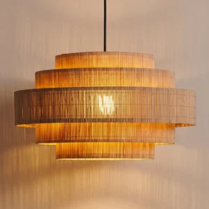 Auden tiered bamboo pendant light installed in warm interior space, close-up front view showing woven texture and ambient glow