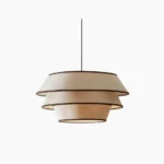 Auden tiered pendant light with beige linen shade and black trim, front view on white background
