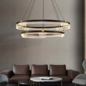 Aura double-tier acrylic pendant light installed above modern brown leather sofa with warm ambient illumination