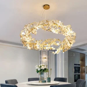 Aurea chandelier illuminated in modern dining room, warm glowing brass and glass crystal fixture