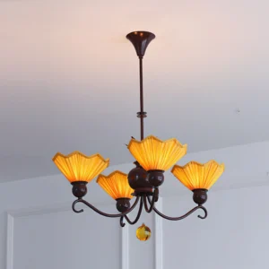 Aurelia 4-light pleated chandelier featuring warm amber shades and curved metal arms, minimalist interior setting