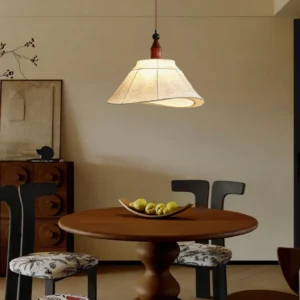 Aurelian pendant light hanging in vintage dining room with wooden round table, warm ambient lighting