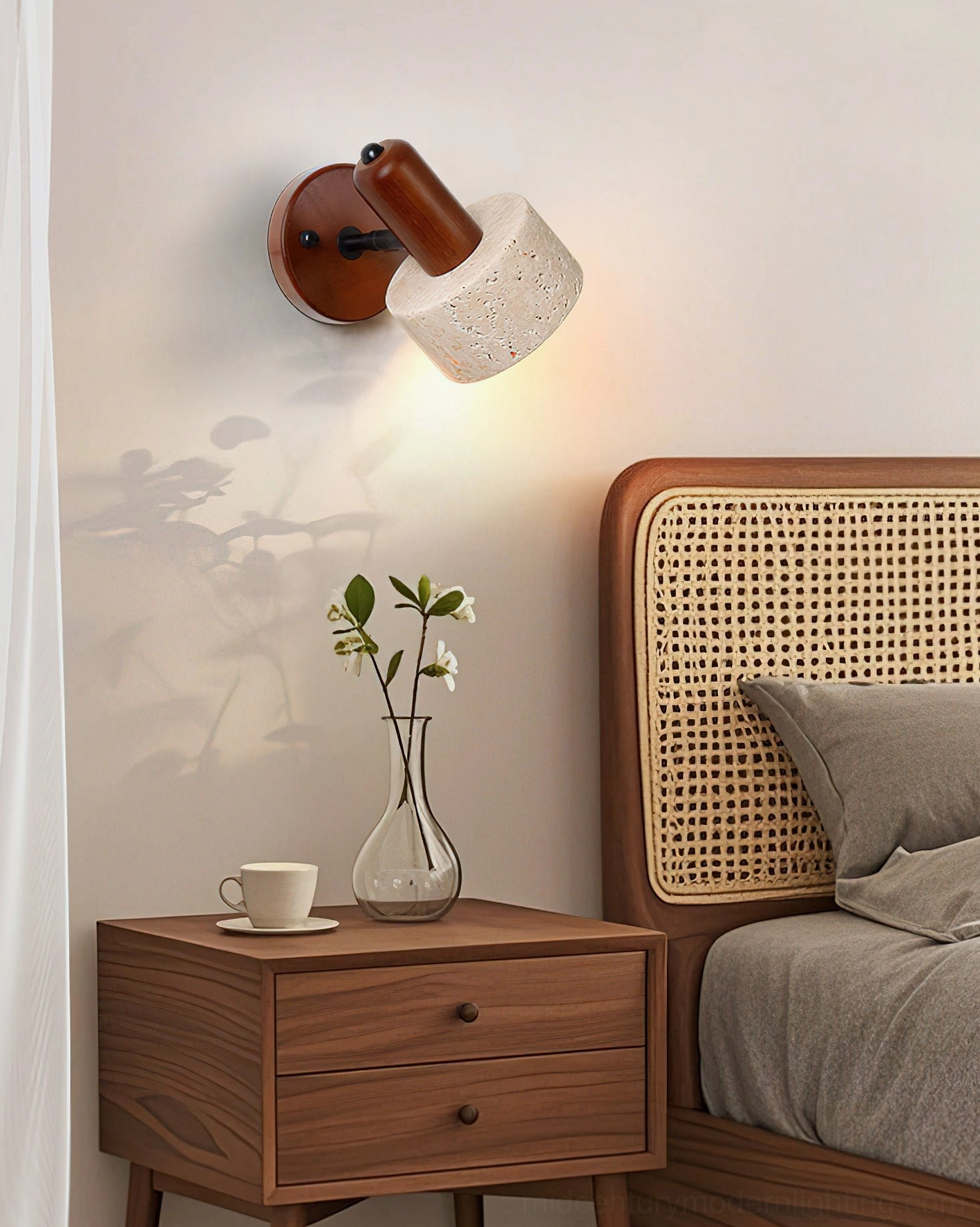 Aureole travertine wall light mounted above bedroom nightstand with wooden furniture