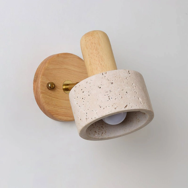 Aureole wall sconce close-up showing natural porous travertine texture and light wood base detail