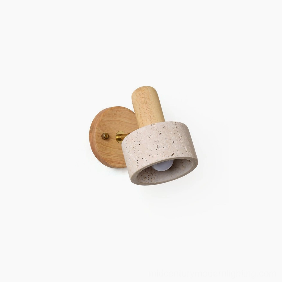 Aureole organic modern wall sconce with travertine shade and light wood backing, three-quarter close-up view on plain background