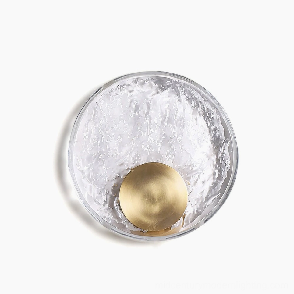 Full view Aurum circular brass wall sconce with opaque crystal shade, professional product photography