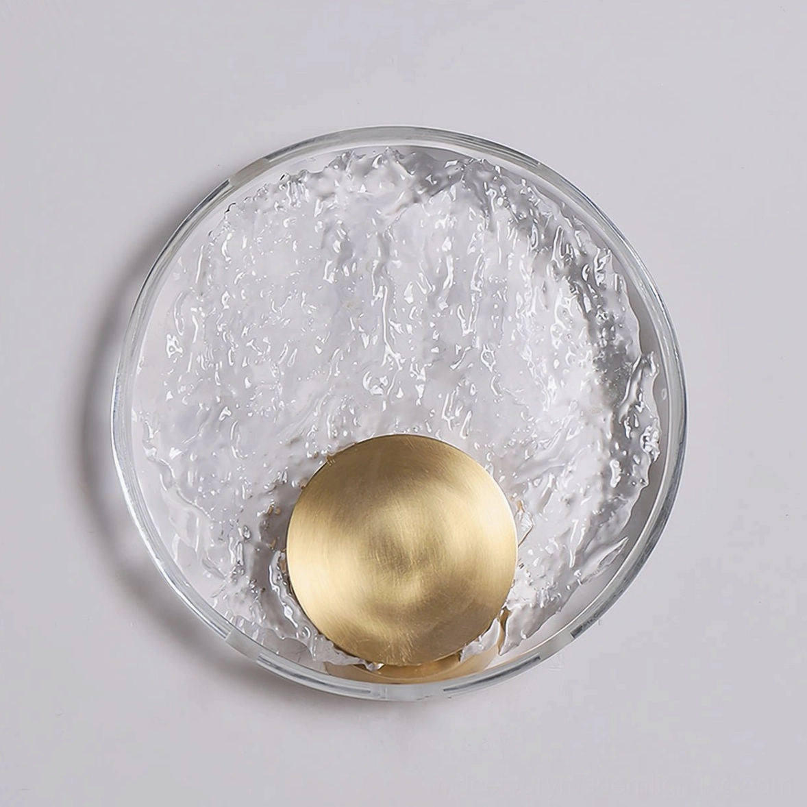 Brass circular wall-mounted luminaire with opaque crystal shade, modern home accent lighting fixture