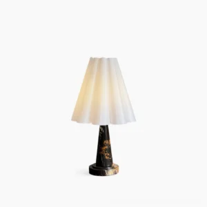 Aveline pleated table lamp with white conical shade and black marble base with gold veining, studio shot on white background