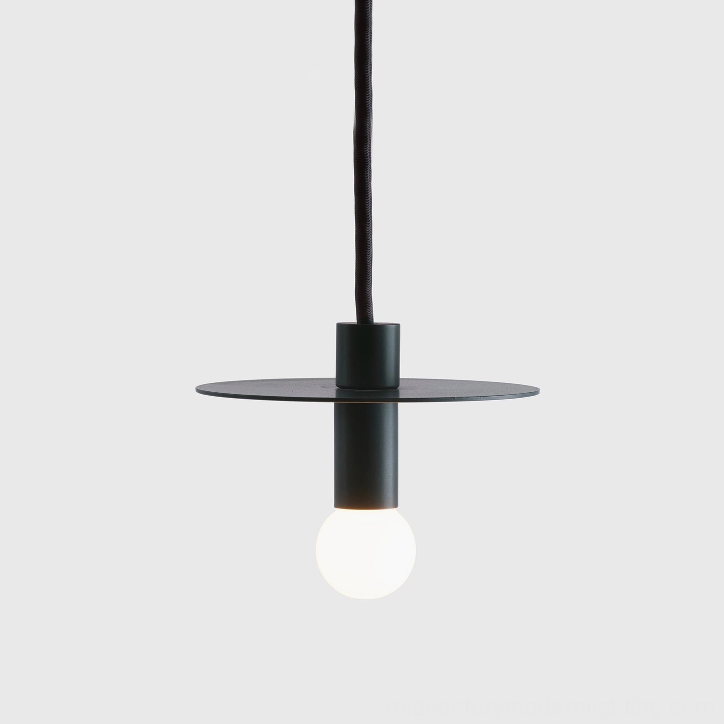 Side angle view of Avida pendant ceiling light showing flat metal disc shade and cylindrical mounting fixture