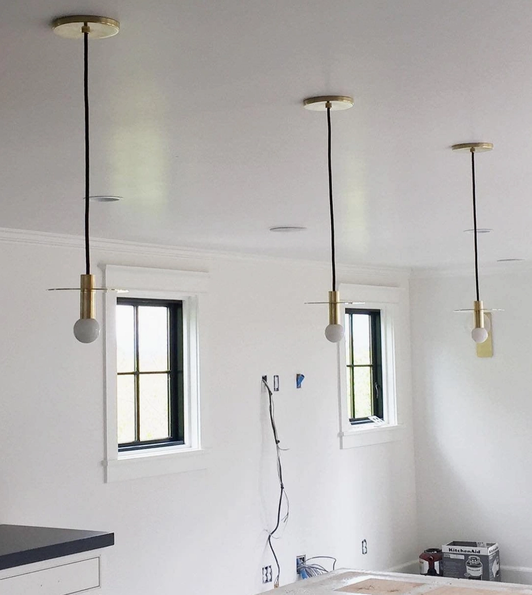 Avida pendant lighting in white finish mounted on ceiling in minimalist modern residential interior space