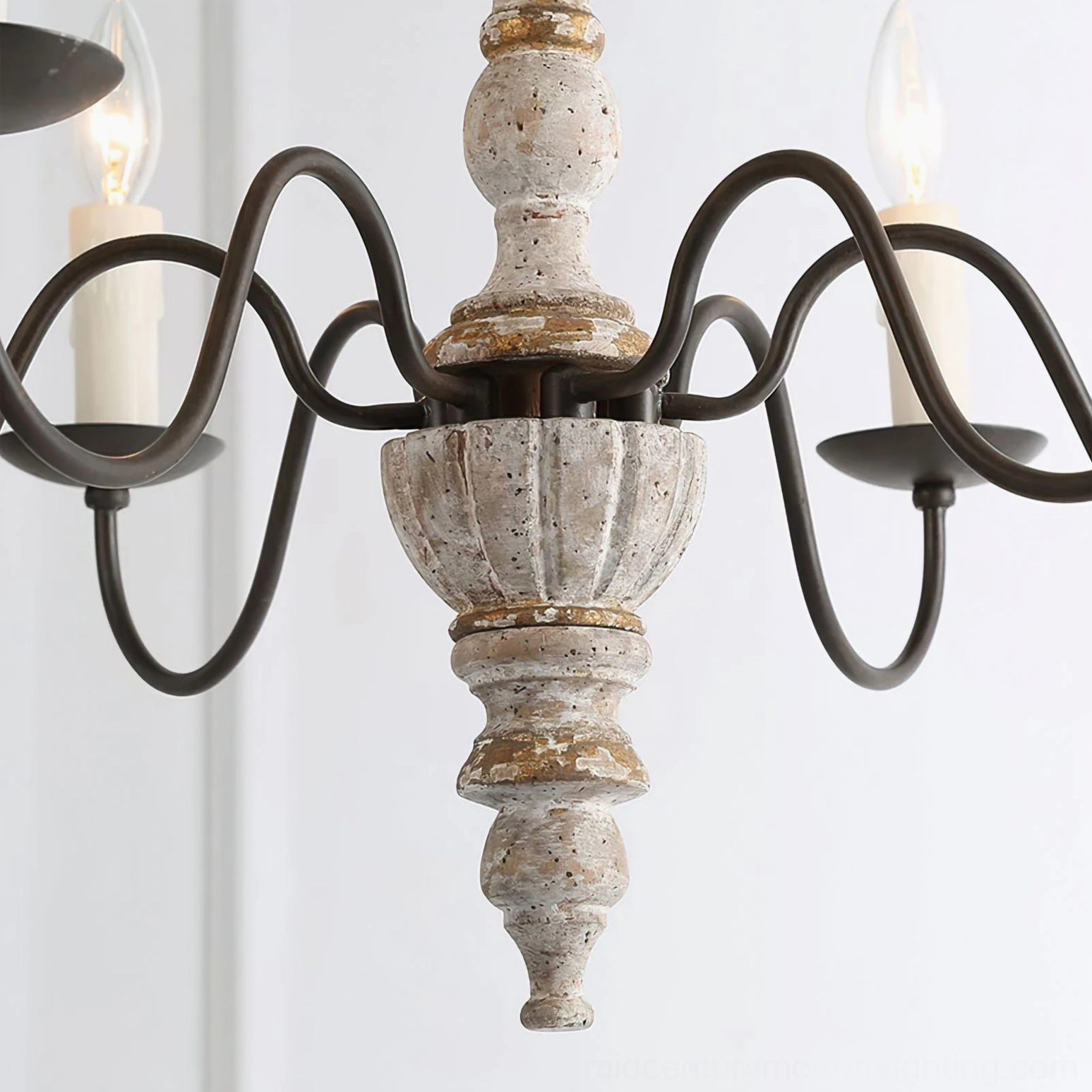 Low-angle close-up of Avignon chandelier showing detailed carved distressed wood fixture with black scroll arms and exposed candle design
