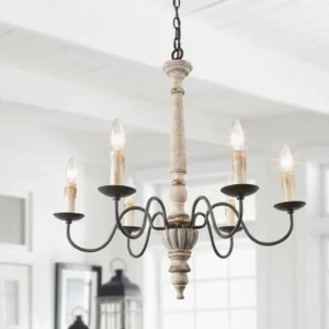 Farmhouse chandelier hanging in bright residential dining space, eye-level frontal perspective showing carved distressed white wood frame and French country style