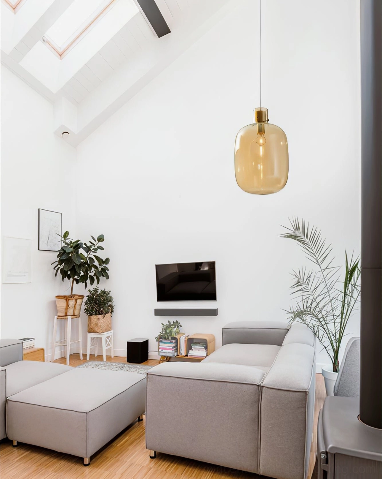 Single Awa pendant light with amber blown glass oval shade, minimalist hanging design in modern bright living room
