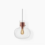 Awa pendant light with clear blown glass shade and rose gold metal fixture, minimalist modern design, flat lay studio view