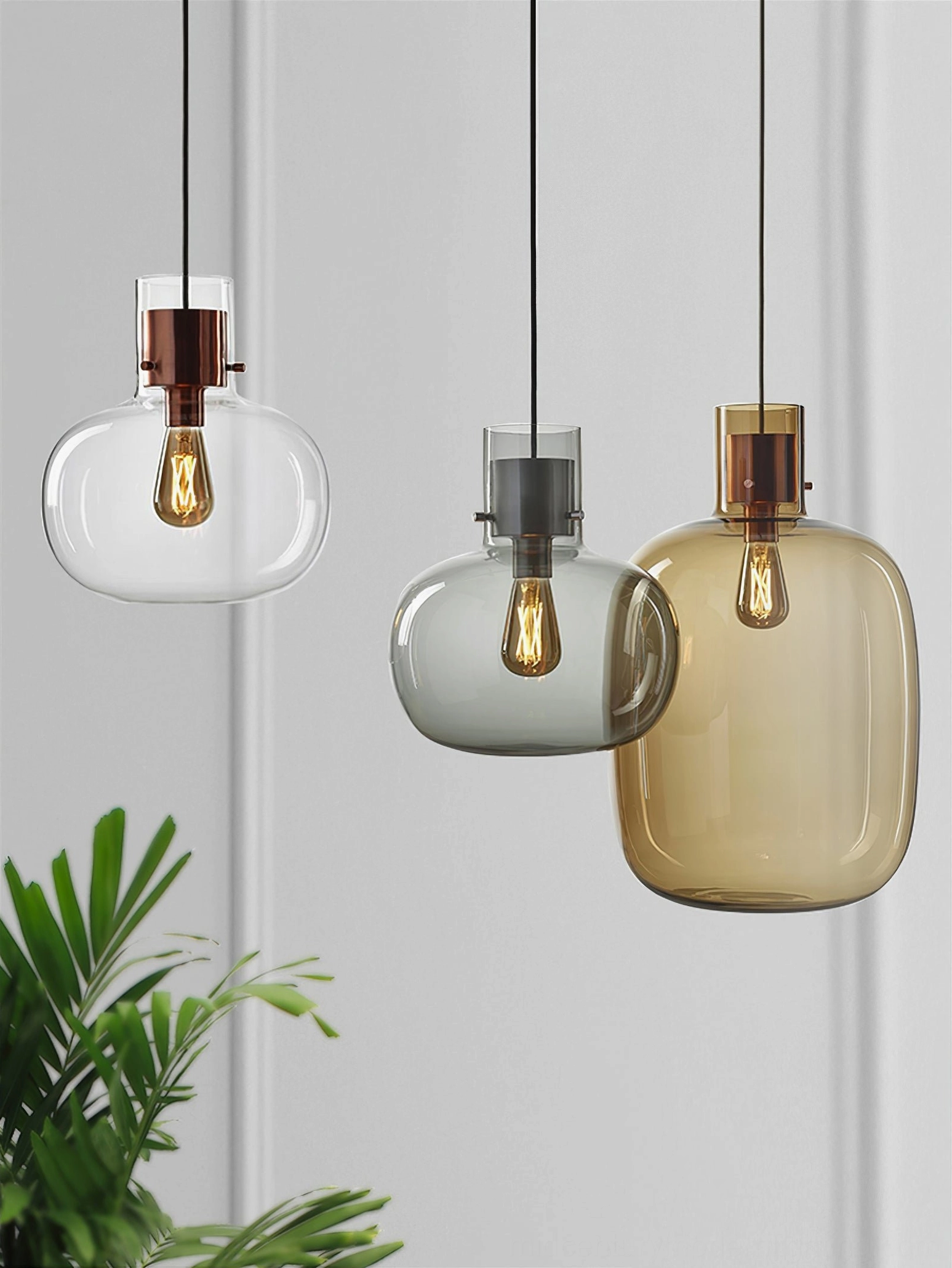 Awa pendant light in cognac glass with copper hardware, warm ambient lighting, decorative interior accent