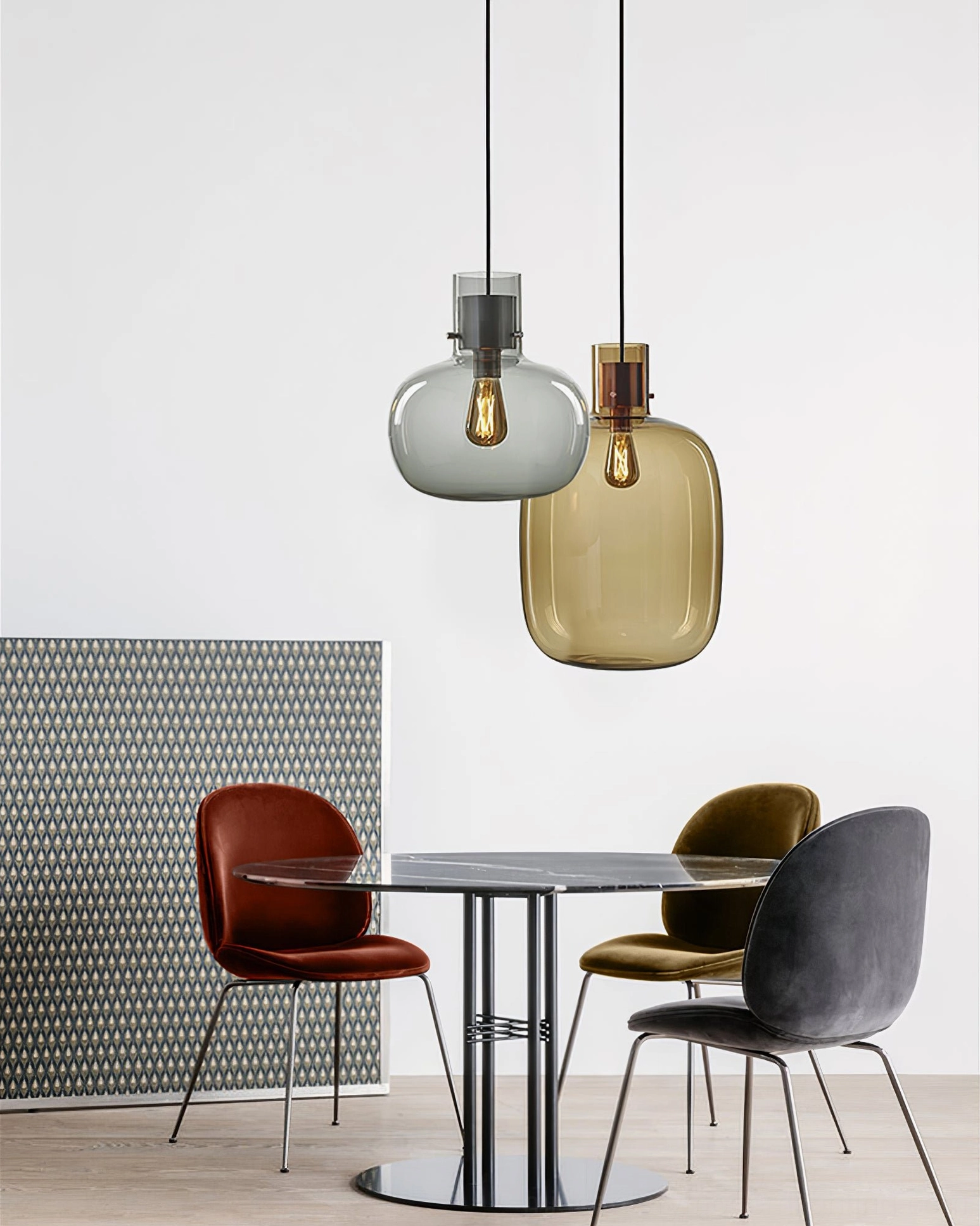 Dual-tone Awa pendant light set with grey and amber blown glass, mixed metal finishes in modern dining nook