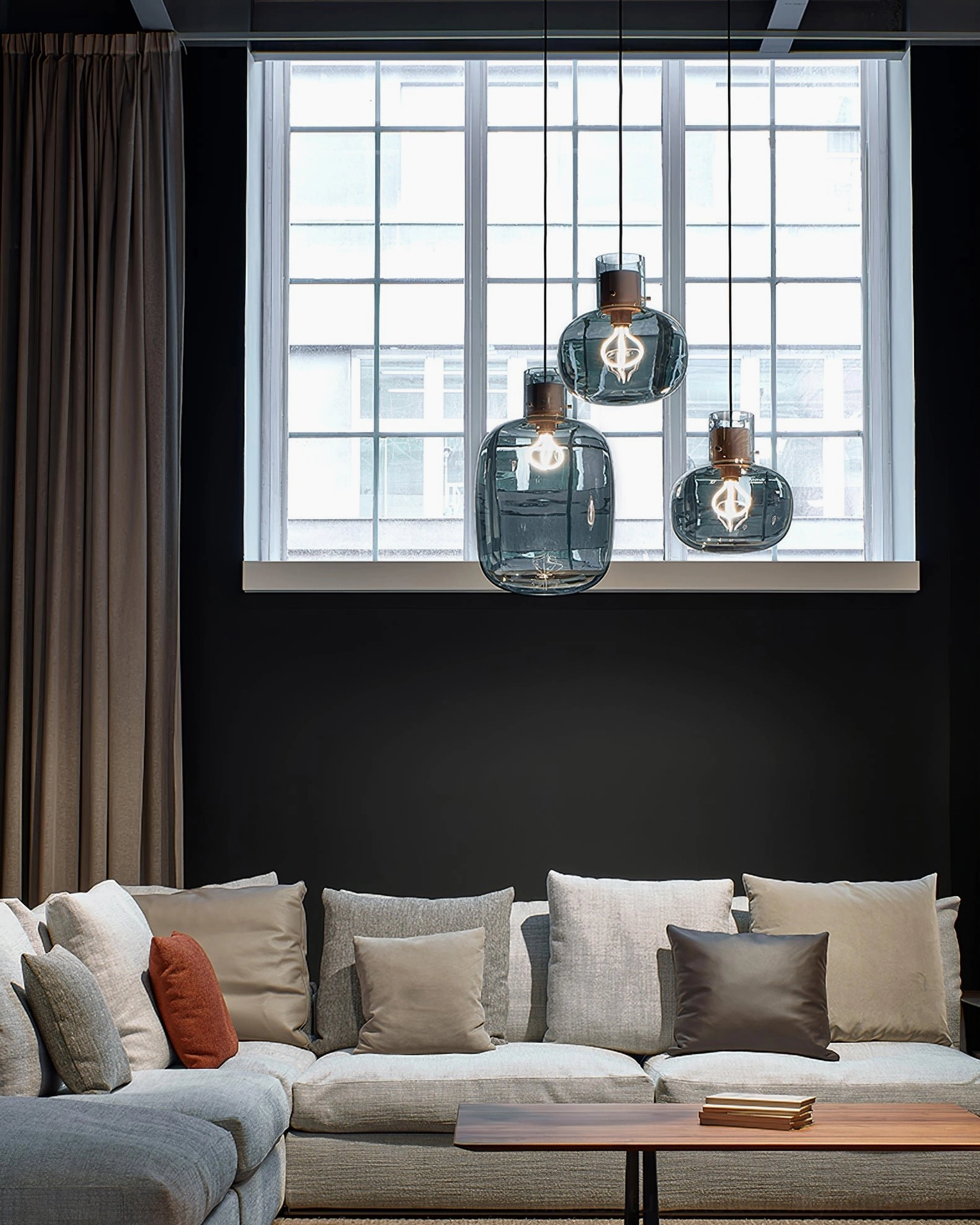 Cluster of Awa pendant lights with deep blue rounded glass shades, modern living room with large window